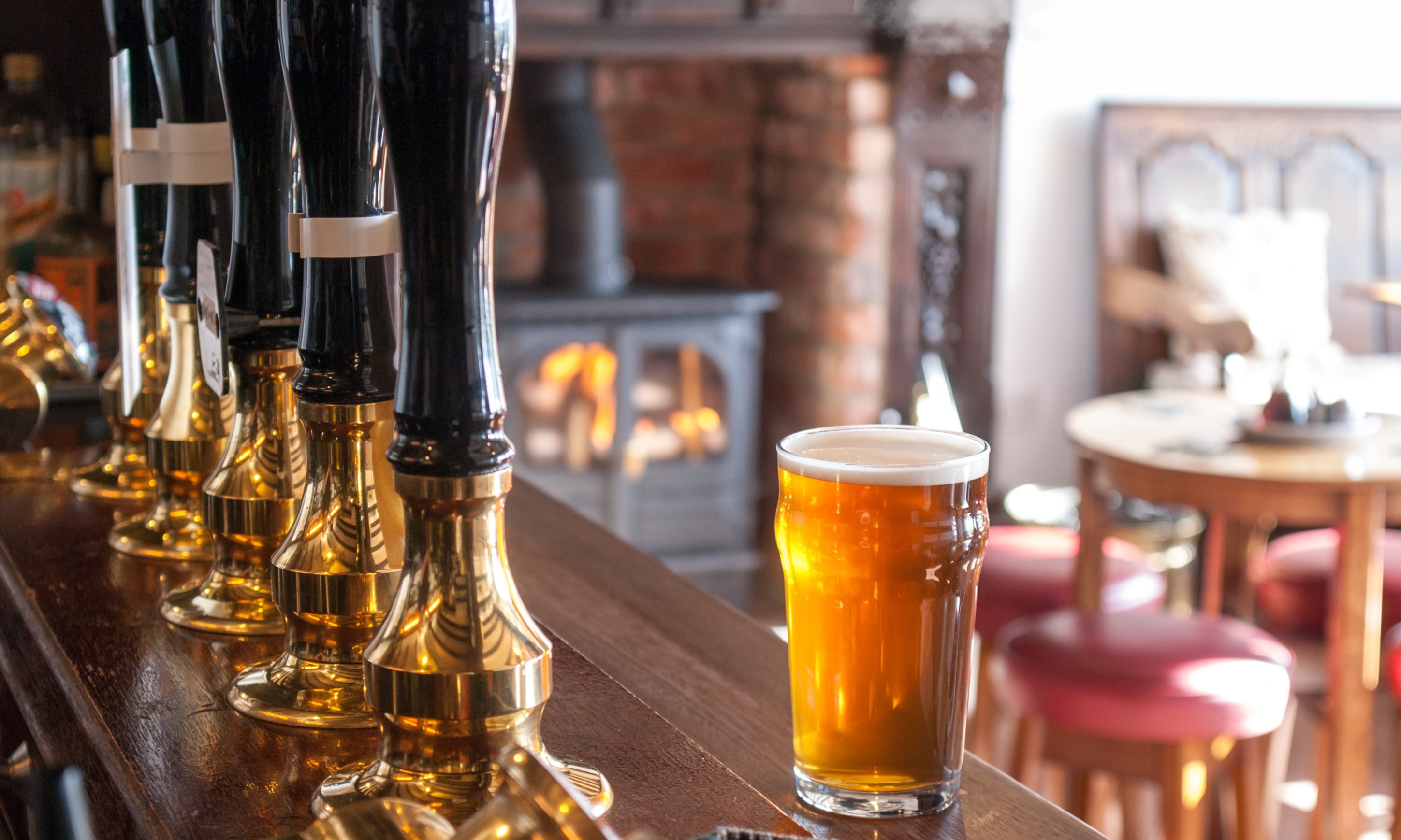 A oint of bitter on a bar in a traditional English pub
