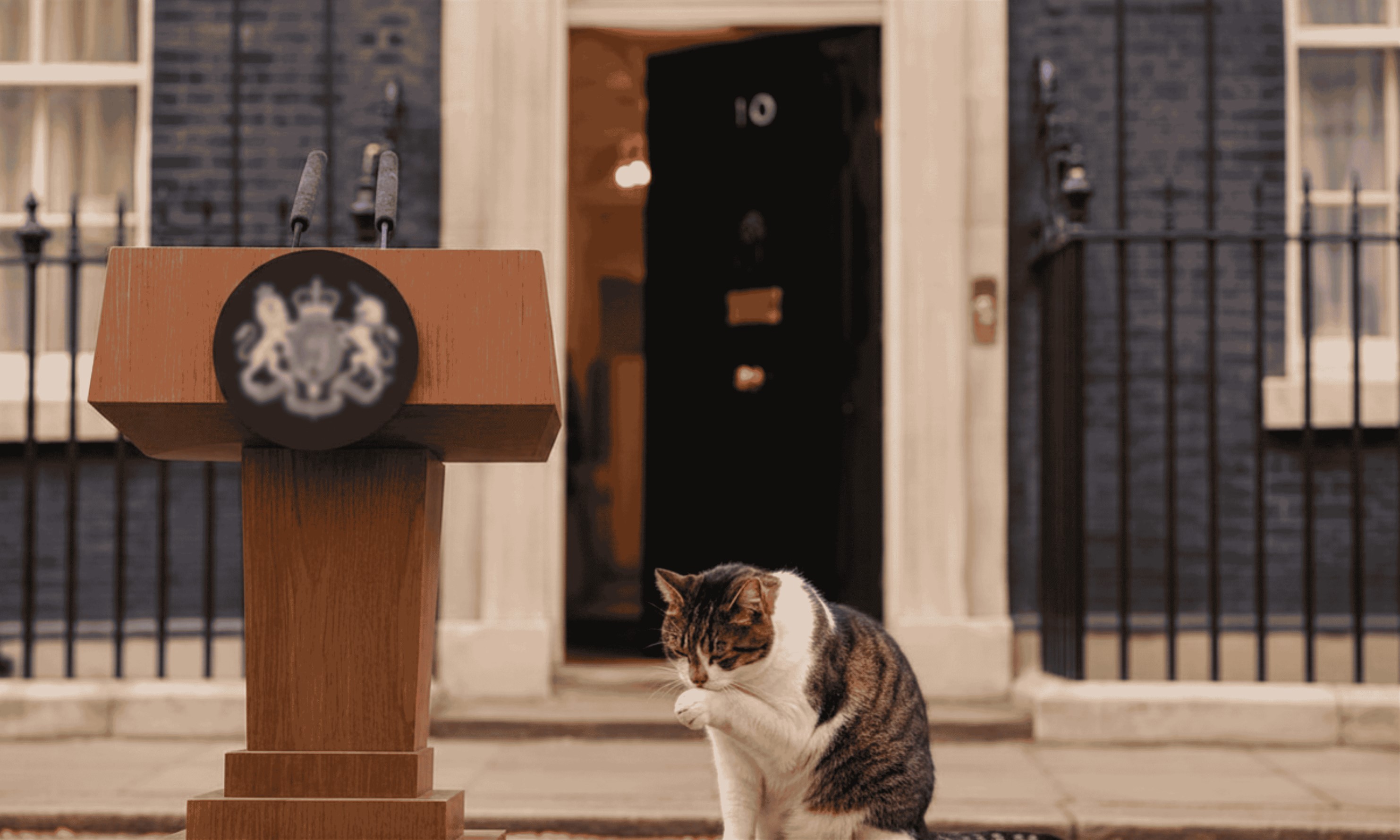 Who will be next through the famous black door at 10 Downing Street? An AI generated image: Larry the Cat licks his front paw nonchalantly in front of the slightly ajar door at Number 10 Downing Street