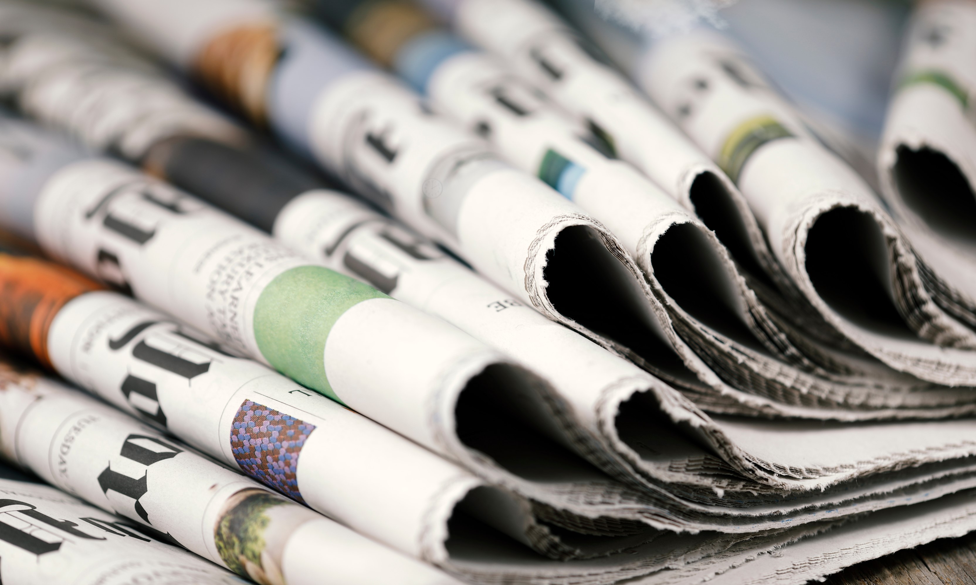 How do you make sense of news about the property market when reports seem so contradictory? A pile of folded newspapers representing the news cycle
